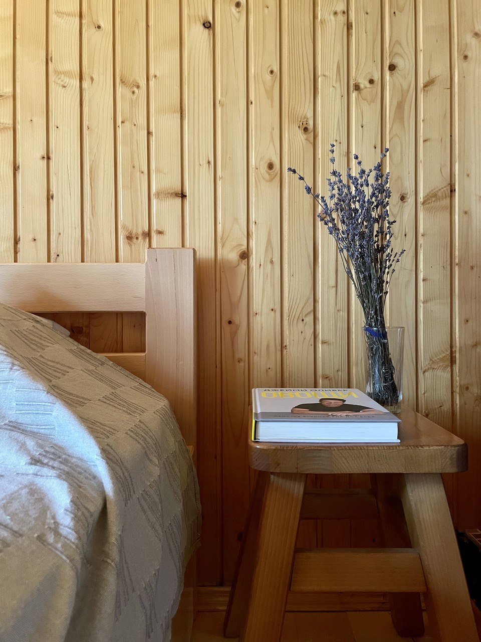 Side-bed table with book and flowers